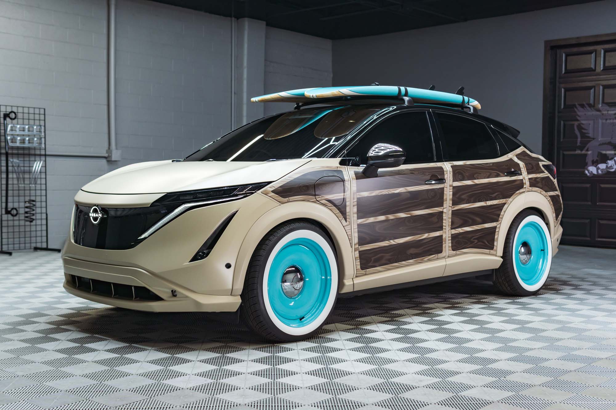 Designed to inspire EV owners to personalize their vehicles to fit their lifestyles, the Nissan Ariya Surfwagon concept reimagines the 2023 Ariya as a California-style surf “woodie” wagon."