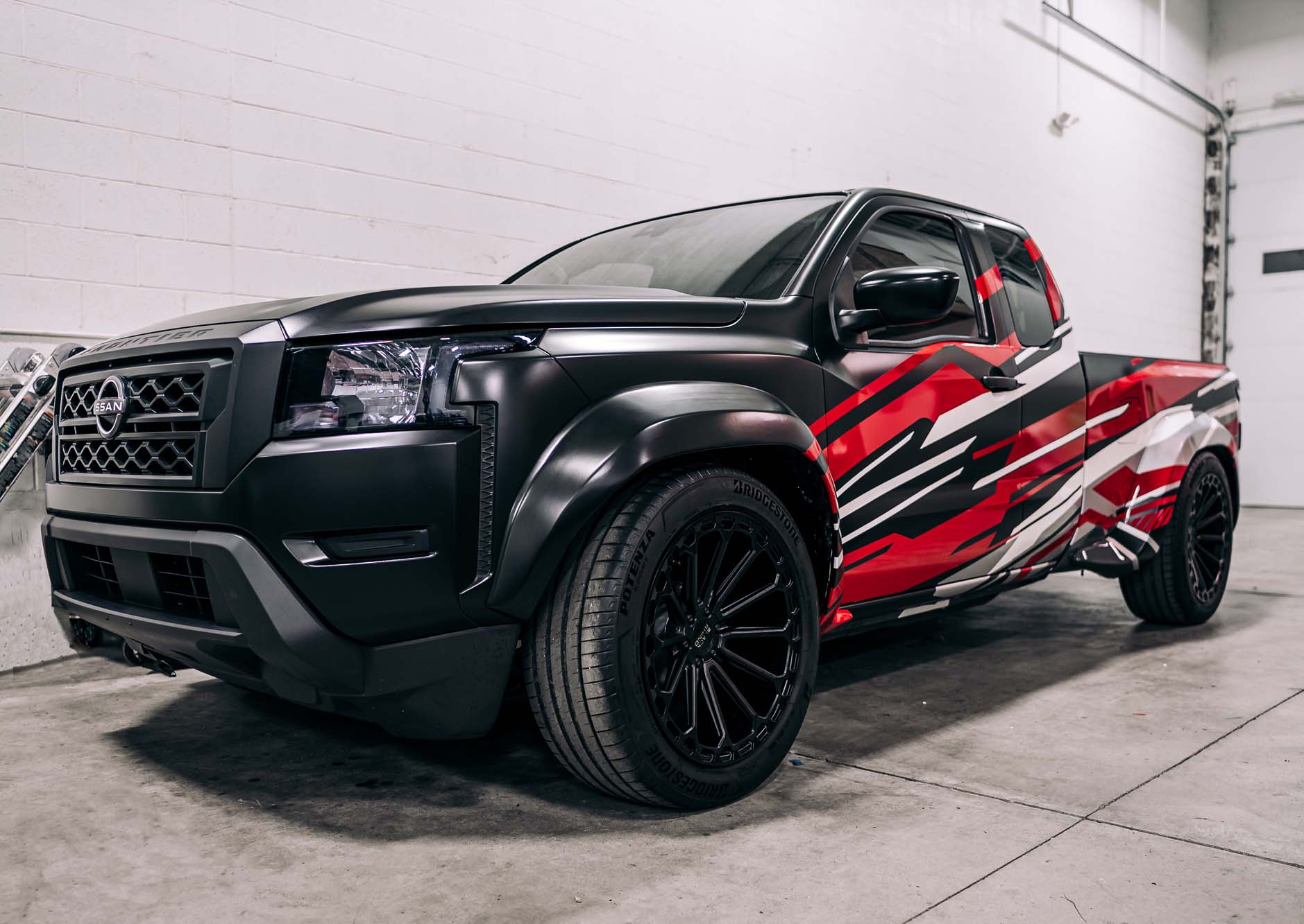 Content creator and automotive influencer Christina Roki created a lowered, street truck-style project based on a 2022 Frontier King Cab SV. Roki takes the truck in a bold direction with a custom wide body kit from Performance Lab Detroit, along with a lowered suspension and other modifications, all recalling the look of the “mini truckin’” style of the past.