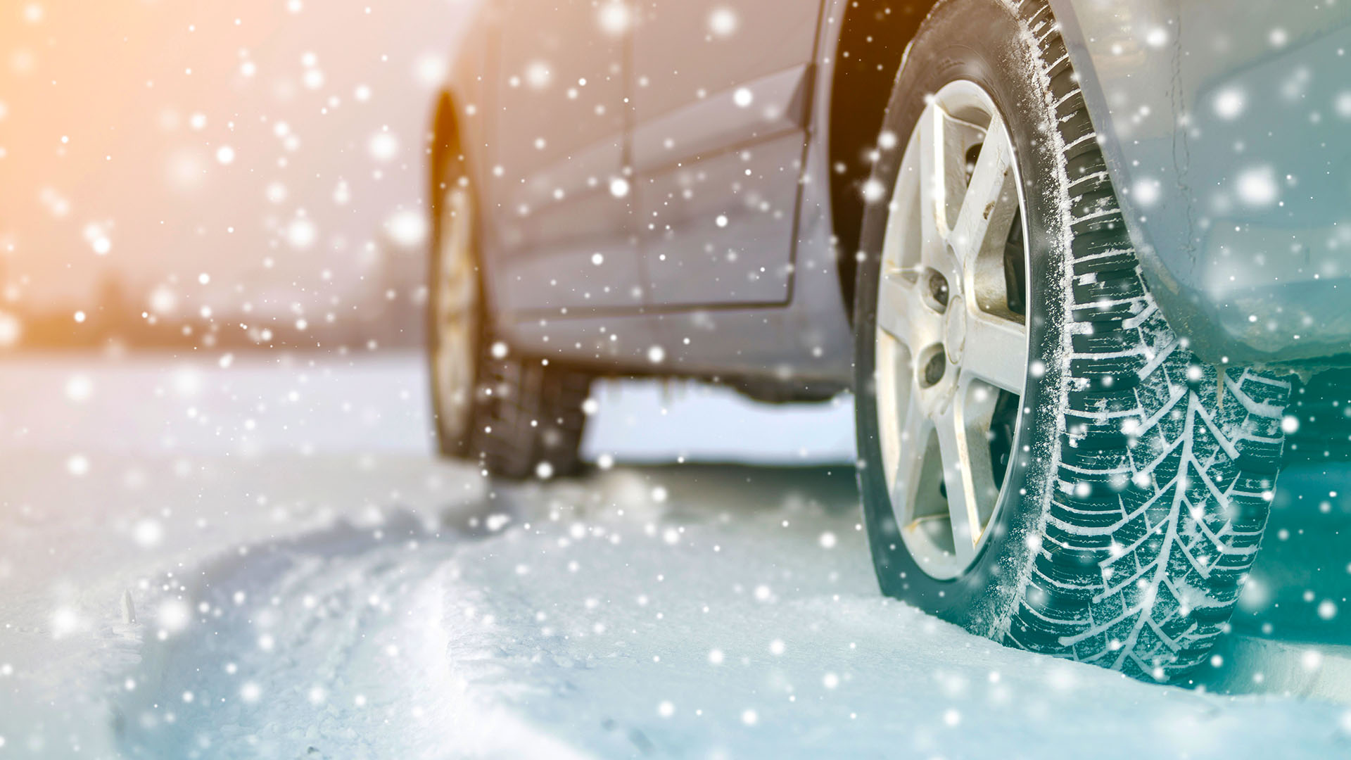 Close-up of car wheels rubber tires in deep winter snow. Transportation and safety concept.