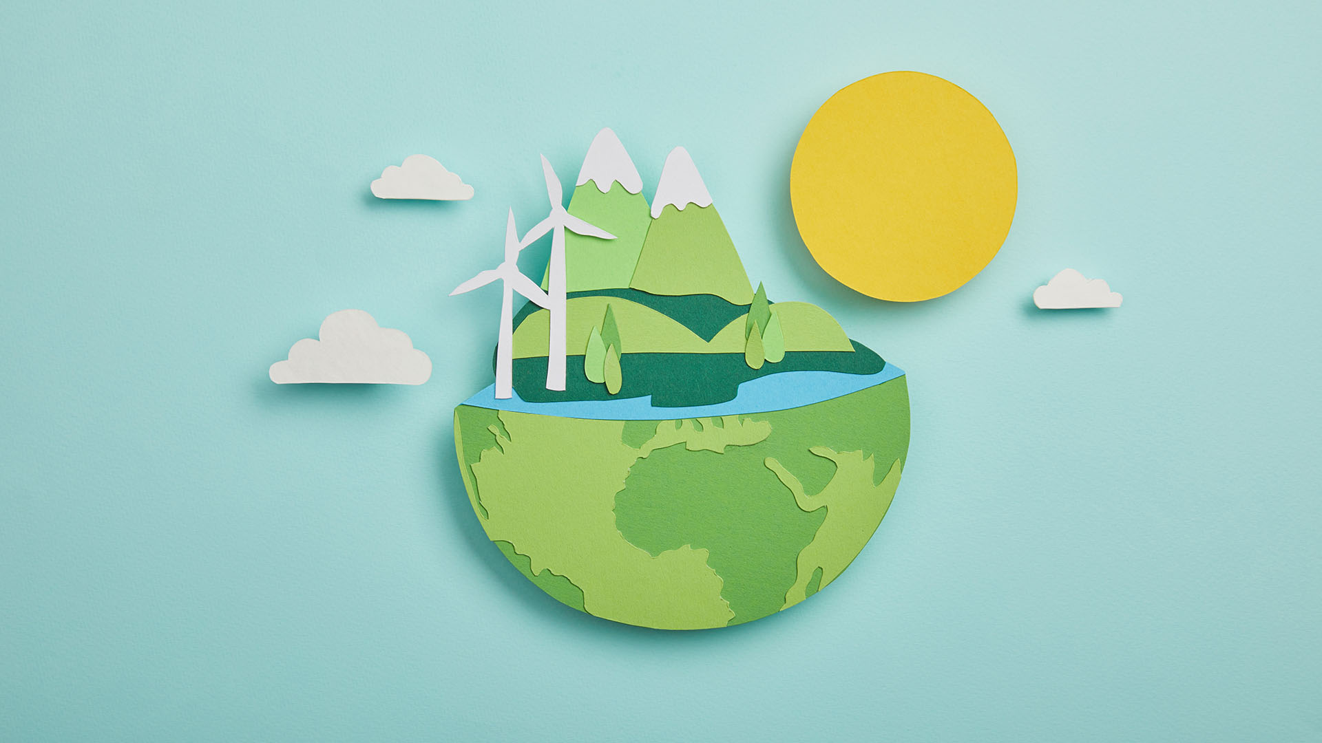 top view of paper cut planet with renewable energy sources on tu