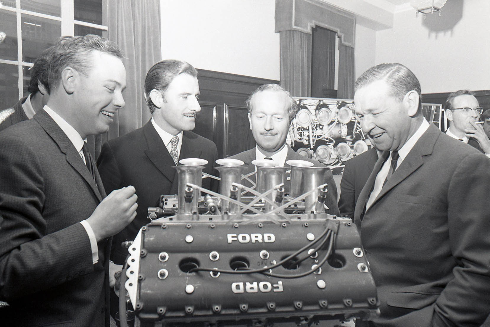 Keith Duckworth, Graham Hill, Colin Chapman, Frank Costin Ford DFV V8 Keith Duckworth, Graham Hill, Colin Chapman, Frank Costin Ford DFV V8