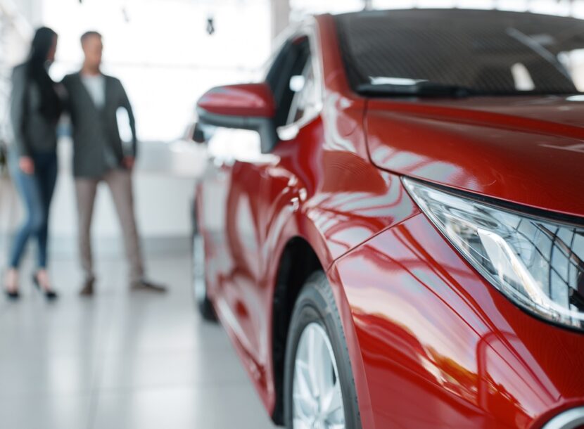 envato couple buying new red car in showroom 2026 01 06 09 43 35 utc